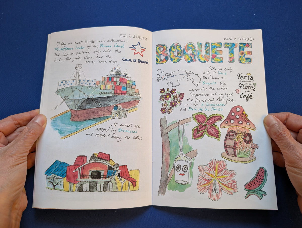 An open illustrated journal held by two hands against a blue background. The pages contain colorful drawings, handwritten notes, and decorative illustrations including a cargo ship, flowers, houses.